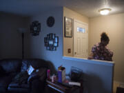 Vancouver resident Charmaine Crossley pauses in the front hallway of her rental home while helping her son prepare for football practice Wednesday. Crossley is facing possible eviction.