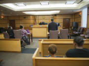 Judge Robert Lewis, top center, oversees the evidentiary hearing of Vancouver resident Charmaine Crossley, second from left. Crossley’s case was continued to Nov. 3.