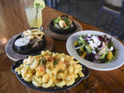 Lobster mac and cheese, clockwise from front, is pictured with the steak tips, roasted seasonal veggies and roasted beet salad at Sixth Avenue Bistro.