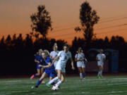 King’s Way junior Kate Roseburrough spins around La Center freshman Madison McCuddy at King’s Way High School on Thursday, October 5, 2017. King’s Way routed La Center 7-0.