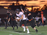 Hockinson receiver Sawyer Racanelli runs the ball with Washougal line backer Nathan Tofell looming over him at Washougal High School on Friday, October 6, 3017.