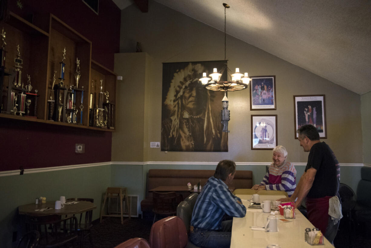 Terry Hurd, of Ridgefield, chats with co-owner Charlene Jollie and David Jollie at Jollie’s Restaurant & Lounge in Ridgefield. The restaurant will close after 54 years on Sunday. Hurd said he remembered coming to the restaurant with his parents.