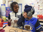 Benaiah Toussaint, 6, from Haiti and Amritpal Singh, 6, from India, sing together while working on iPads in their English language learning class for first through third grades in the Fircrest Elementary School Newcomers Program on Tuesday. Students learn English and about the United States’ culture while enrolled in the program.