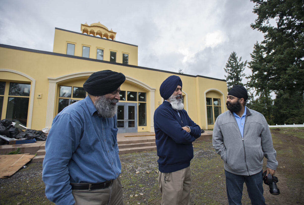 Secretary Gurjit Singh, left, joins vice president Kamal Bains and volunteer spokesman Pawneet Sethi as they look over the construction at Guru Ram Dass Sahib Gurdwara in Northeast Vancouver last Friday afternoon.