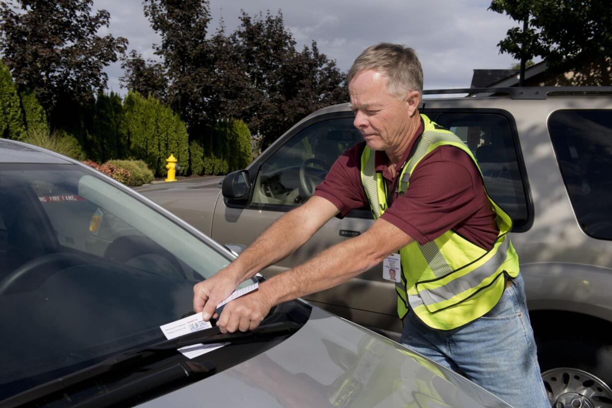 Vancouver Police are starting a program to encourage voluntary license compliance. NOW (Neighbors On Watch) volunteers are taking to the streets of Vancouver to inventory out-of-state license plates in neighborhoods. Scott Abels, a NOW volunteer, puts a notice on a car with out-of-state license plates in the Landover-Sharmel neighborhood. On top off loosing revenue from license plate cheats, the city of Vancouver could be missing out on $4 million in sales tax as a result of Washington residents keeping their Oregon driver’s licenses and opting out of sales tax at the register.