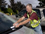 Vancouver Police are starting a program to encourage voluntary license compliance. NOW (Neighbors On Watch) volunteers are taking to the streets of Vancouver to inventory out-of-state license plates in neighborhoods. Scott Abels, a NOW volunteer, puts a notice on a car with out-of-state license plates in the Landover-Sharmel neighborhood. On top off loosing revenue from license plate cheats, the city of Vancouver could be missing out on $4 million in sales tax as a result of Washington residents keeping their Oregon driver’s licenses and opting out of sales tax at the register.