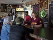 Bill and Elizabeth Walters chat with customers Tasha Wood and Amy Graeff, both of Vancouver, at The Rusty Chain in Vancouver’s Carter Park neighborhood on Friday afternoon. Wood and Graeff live nearby and say the bar and grill is their favorite spot.