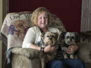 Raelene Jarvis sits with her two dogs, Jessie and Gracie, at her home in Vancouver.