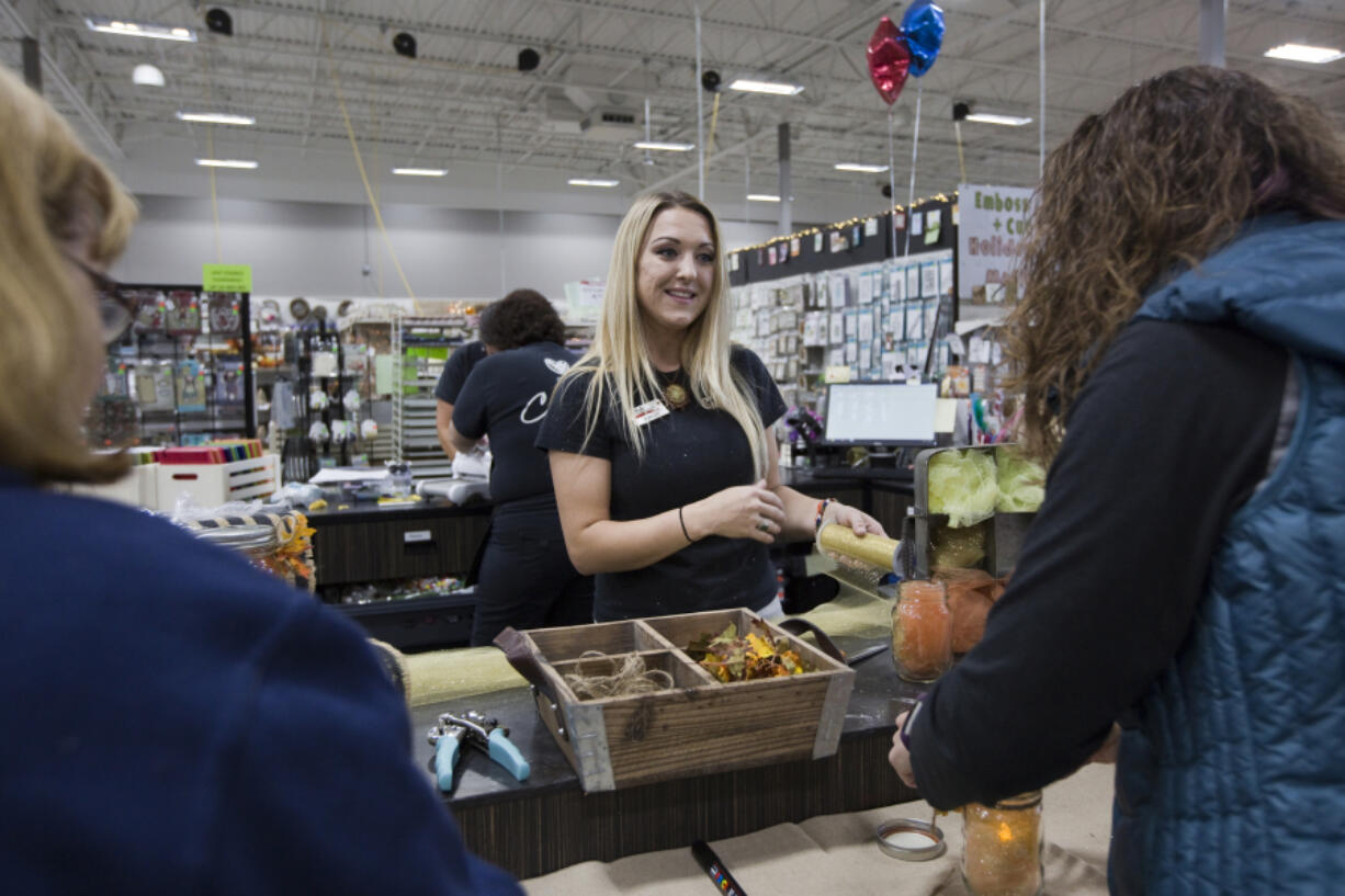 Ashley Gibson, craft components department lead for Craft Warehouse, encourages crafters in a workshop in the Hazel Dell store.