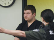 Justin Lee Smith-Riggs, 20, suspect in a burglary and arson at the nonprofit Tilikium, makes a first appearance in Clark County Superior Court on Monday morning.