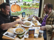 Mayor Tim Leavitt, left, serves himself whole-wheat pasta, tuna fish and peas at lunch Tuesday with Share volunteer Kenny Dunn at Beaches Restaurant. The meal was created using items from backpack food distributed to local low-income students.