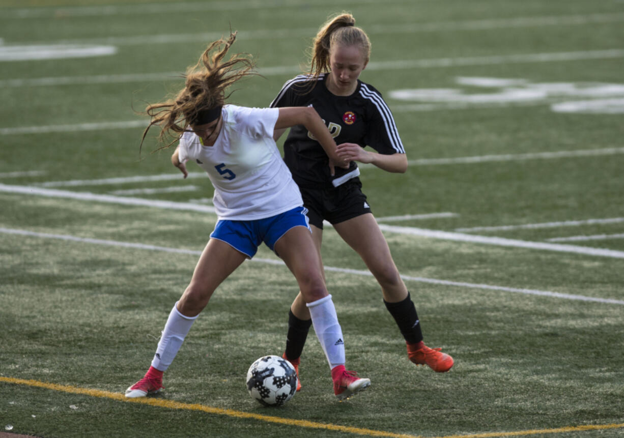 Mountain View’s Alexis Sadler (5) tries to maneuver away from Prairie’s Morgan Borwieck (32) during Wednesday night’s game at McKenzie Stadium. Mountain View defeated Prairie 3-0.