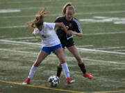 Mountain View’s Alexis Sadler (5) tries to maneuver away from Prairie’s Morgan Borwieck (32) during Wednesday night’s game at McKenzie Stadium. Mountain View defeated Prairie 3-0.