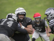 Union’s Sausau Faalevao, second from right, takes on teammates during practice Tuesday afternoon, Oct. 10, 2017.