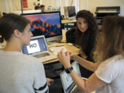 Professor Dene Grigar, center, discusses design with seniors Polina Sklyarova, left, and Brianna Savage during the digital technology and culture program’s senior seminar Wednesday afternoon at Washington State University Vancouver. The Historic Trust recently partnered with the program to create a new tool that will allow visitors to experience the history of Providence Academy through augmented reality on their mobile devices.