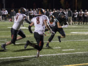 Woodland’s Tyler Flanagan (21) scores the first touchdown of the night during Friday’s 2A Greater St. Helens League game against Washougal.