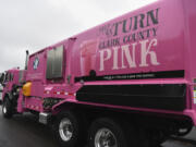 Waste Connections unveiled a pink recycling truck in August to raise awareness about pink recycling carts sold to benefit the local breast cancer nonprofit Pink Lemonade Project. Top: Jarett Hill, a Waste Connections driver, has fliers to distribute to people who ask about the pink recycling truck and carts. Pink recycling carts are available with a $100 donation to the Pink Lemonade Project.