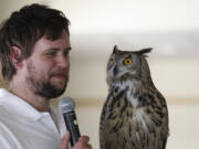 John Prucich, a falconer and biologist who works at the Woodland Park Zoo and Northwest Trek Wildlife Park, on Sunday shows a Eurasian eagle-owl named Wednesday for Clark County’s Green Neighbors Program.