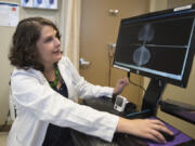 Dr. Cory Donovan looks over mammogram images Thursday morning at Legacy Good Samaritan Medical Center in Portland. Donovan, a breast surgical oncologist, will soon split her time at Good Sam and Legacy Salmon Creek Medical Center.