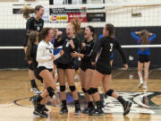 Woodland celebrates winning the fourth set and match against Ridgefield on Thursday, earning the top seed for the upcoming district tournament.