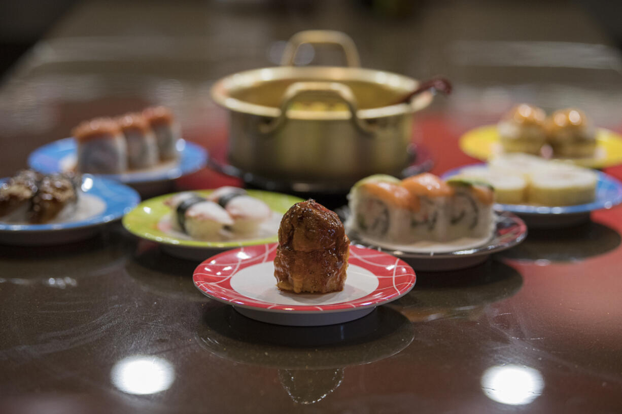 A Volcano Roll, front, is served with a selection of other sushi dishes at Gogo Sushi.