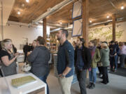 Anthony Vendetti of Vancouver, center in navy blue, waits in line to place his order at The Mighty Bowl’s restaurant in downtown Vancouver. The new restaurant will be open Monday through Friday.