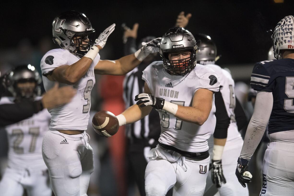 Union's Dustin Nettles (9) and Aiden Nellor (87) react after recovering a Skyview fumble in the first quarter at Kiggins Bowl on Friday night, Oct. 20, 2017.