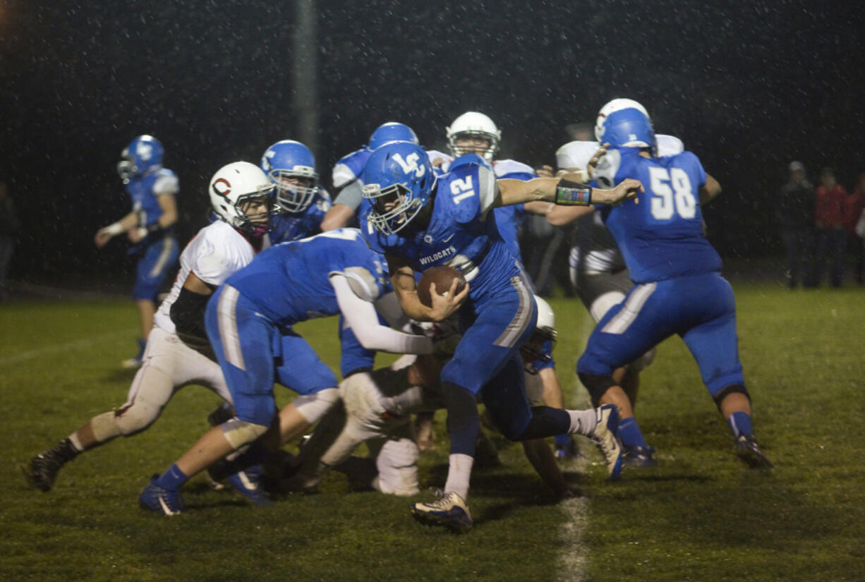 La Center Wildcat Collin Namanny (C) runs with the ball during a game against the White Salmon Bruins in La Center Friday October 20, 2017.