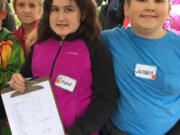 North Image: Image Elementary School fifth-graders, from left, Ellie Fidkevich, Emma Vasxquez and Jenson Weismann on a field trip to the 78th Street Heritage Farm to learn more about agriculture and where food comes from.