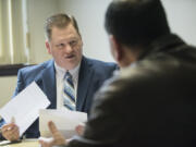 Volunteer attorney Ben Moody gives a client legal advice during a meeting at the Clark County Courthouse on Friday. Moody typically volunteers every Friday giving advice to people facing evictions.