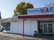 The front facade of Laundry Love, a coin-operated laundromat, was repaired and the cinder block exterior repainted after a Dodge Charger crashed into the building in May. The laundromat could open next month.