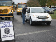 Washington State Patrol Sgt. Glen Hobbs directing a driver to pull over for having out-of-state license plates. If a driver is found to live in Washington but has out-of-state plates, it could result in a $1,122 ticket.