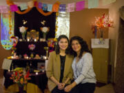 Gloria Pitkin, left, and her mother, Rosalba Pitkin, are pictured in front of an ofrenda, or altar, set up in their living room to commemorate deceased loved ones for Day of the Dead. “This is my family’s tradition. This is my history and my home. It’s very important to me to know about it and know what it means,” Gloria Pitkin said.