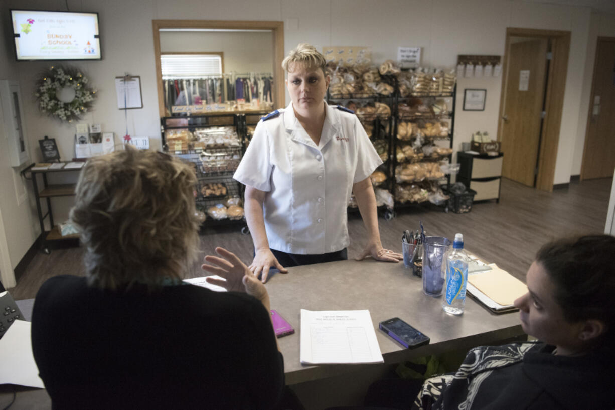 Samantha Wheeler, the ministry leader at the new Salvation Army headquarters in Washougal, talks Wednesday with volunteers at the front desk.