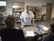 Samantha Wheeler, the ministry leader at the new Salvation Army headquarters in Washougal, talks Wednesday with volunteers at the front desk.