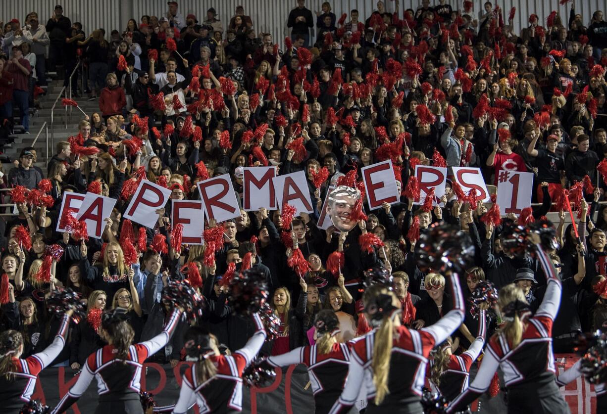 The Camas fan section cheers on their team before Friday night's rivalry game at Doc Harris Stadium in Camas on Oct. 27, 2017.