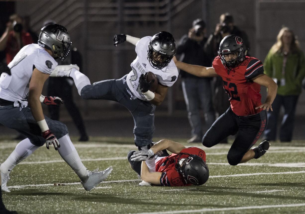 Camas' Ryan Rushall (8) takes down Union's Joseph Siofele (26) during Friday night's rivalry game at Doc Harris Stadium in Camas on Oct. 27, 2017.