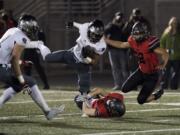 Camas' Ryan Rushall (8) takes down Union's Joseph Siofele (26) during Friday night's rivalry game at Doc Harris Stadium in Camas on Oct. 27, 2017.