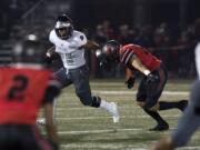 Union's Joseph Siofele (26) holds off Camas' Will Schultz (37) during Friday night's rivalry game at Doc Harris Stadium in Camas on Oct. 27, 2017.