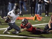 Union's Joseph Siofele (26) scores the team's second as he's brought down by Camas' Isaiah Abdul (2) during Friday night's rivalry game at Doc Harris Stadium in Camas on Oct. 27, 2017. Union defeats Camas 14-13.