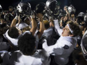 Union celebrates their victory over Camas after Friday night’s rivalry game at Doc Harris Stadium in Camas. The win snapped a 58-game regular season win streak for Camas.