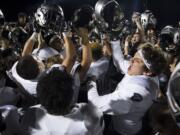 Union celebrates their victory over Camas after Friday night's rivalry game at Doc Harris Stadium in Camas on Oct. 27, 2017. Union defeated Camas 14-13.