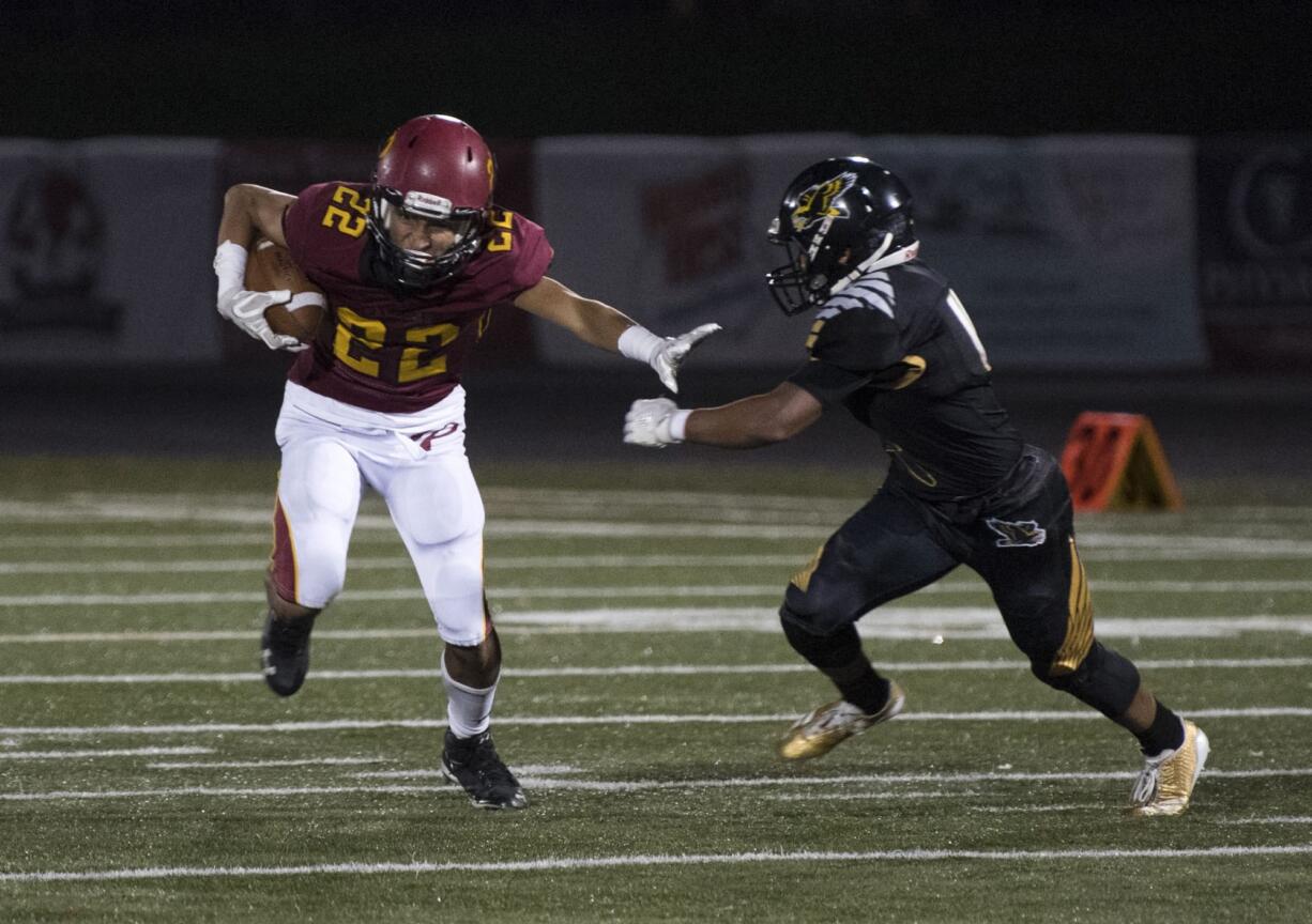 Prairie's AJ Dixson (22) runs downfield as Quadrese Teague (4) of Hudson's Bay closed in during the 3A GSHL tiebreaker at Doc Harris stadium on Monday night, Oct. 30, 2017. Hudson's Bay won the tiebreaker 6-3.