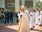 Five Corners: The Most Rev. Daniel Mueggenborg, an auxiliary bishop of the Seattle archdiocese, blessing new athletic fields at Seton Catholic High School on Oct. 14.