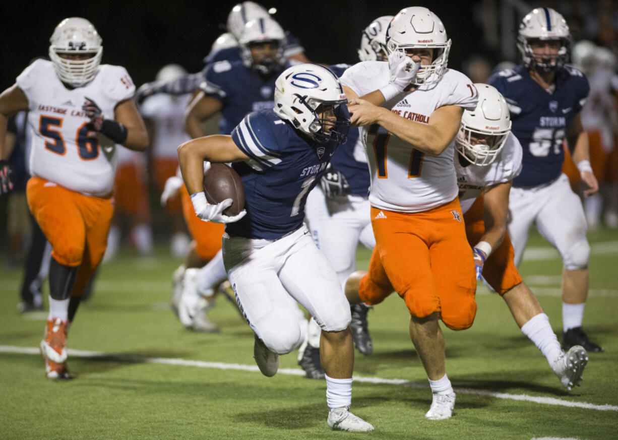 Skyviewís Angelo Sarchi (1) fights off Eastside Catholicís Ryan Taylor (77) during the first quarter at Kigginís Bowl, Friday evening, September 8, 2017.