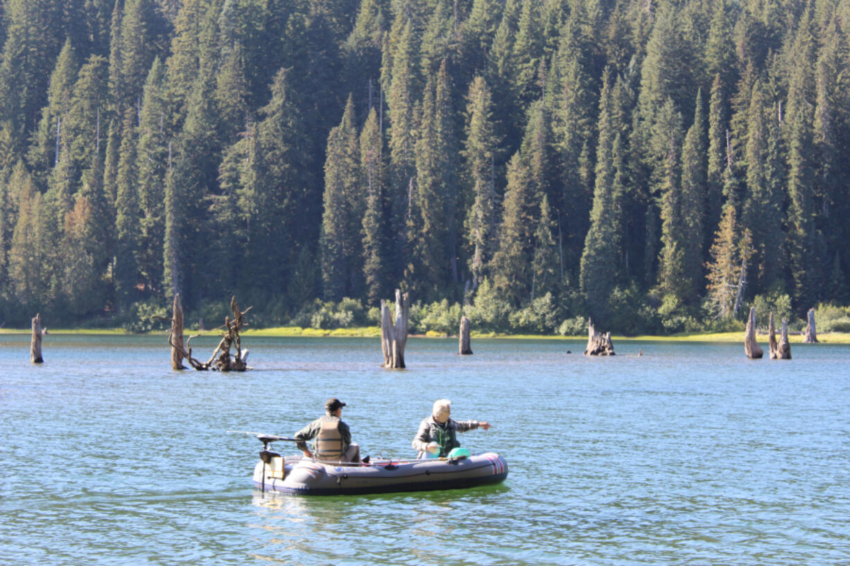 Anglers search for fall trout on Goose Lake. Most troll the lake slowly with bait, flies, or lures, keeping their offering well back of the boat.