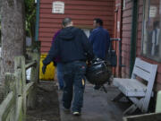 Property management staff clear remaining possessions from tenant patios at the Courtyard Village apartment complex in Vancouver in 2014. Because of new ownership and planned renovations, many tenants were given notices to vacate.