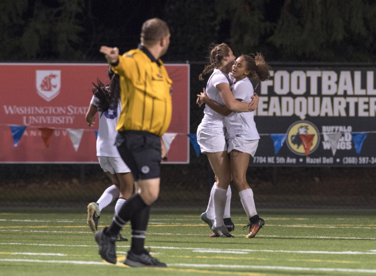 Columbia River’s Sophia Skimas (7) congratulates Shalece Easley (16) after Easley scored a goal during the 2A district semifinals at Kiggins Bowl.