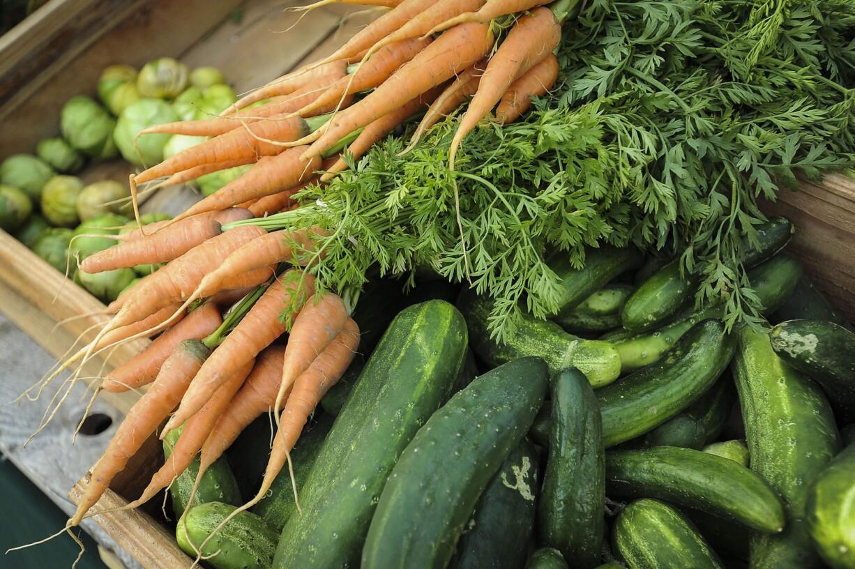 Boxes of fresh produce line the tables at the Salmon Creek Farmers Market at Legacy Salmon Creek Medical Center, Tuesday July 26, 2016.