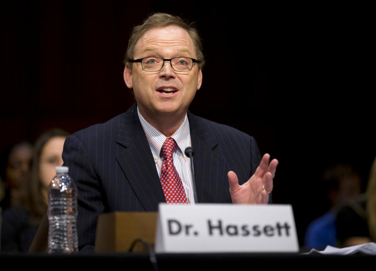 FILE - In this Dec. 6, 2012, file photo, Kevin Hassett, senior fellow and director of Economic Policy at the American Enterprise Institute (AEI), gestures as he testifies on Capitol Hill in Washington before the Joint Economic Committee hearing entitled: "Fiscal Cliff: How to Protect the Middle Class, Sustain Long-Term Economic Growth, and Reduce the Federal Deficit." The analysis by Hassett, President Donald Trump’s chief economist, estimated Monday, Oct. 16, 2017, that the administration's plan to cut corporate tax rates will cause average household incomes to jump $4,000 a year - a stunning 5 percent increase that could be met with skepticism among tax experts and Democratic lawmakers.